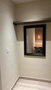 a mirror on the wall of a room with a table at LOL-HA Hotel Boutique in Cancún