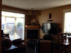 a living room with a couch and a television at Upscale Sooke Vacation Rental in Sooke