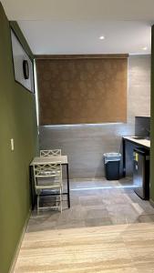 a kitchen with a table and a chair in a room at LOL-HA Hotel Boutique in Cancún