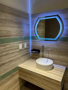 a bathroom with a sink and a mirror at LOL-HA Hotel Boutique in Cancún