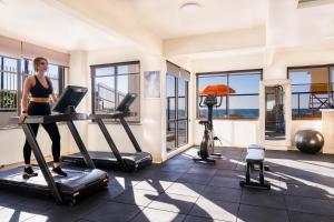 a woman on a treadmill in a gym at Hotel Palace 1 in Florianópolis