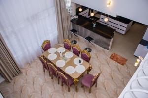 a dining room table and chairs in a living room at ORANA Luxury Palace in Eldoret