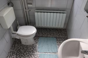 a small bathroom with a toilet and a sink at Gostionica Tava in Tuzla +59 photos