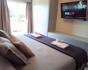 a bedroom with a bed with two towels on it at ALOJAMIENTO CENTENARIO in Corrientes