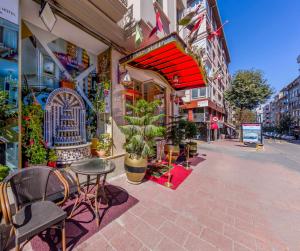 an empty street with tables and chairs on a sidewalk at Lemis Suite Istanbul in Istanbul