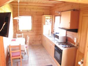 a kitchen in a log cabin with a stove at Haus Rheinsteig bei Koblenz in Lahnstein
