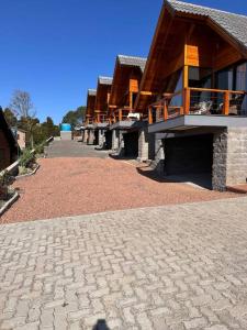 a large building with a brick walkway in front of it at Salto Cabanas Village in São Francisco de Paula
