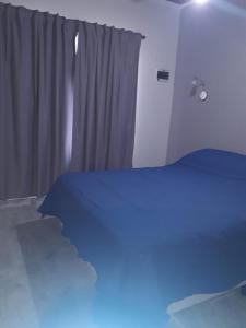 a bedroom with a bed and a window at Cabaña La Luna in San Javier +16 photos