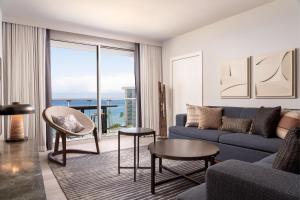a living room with a blue couch and a view of the ocean at The Westin Maui Resort & Spa, Ka'anapali in Lahaina