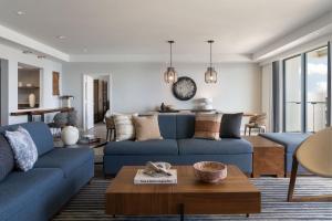 a living room with blue couches and a table at The Westin Maui Resort & Spa, Ka'anapali in Lahaina