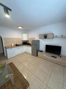 a kitchen with white cabinets and a television in it at Casa Valen Costa Calma in Costa Calma