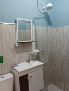 a bathroom with a toilet and a sink and a shower at Studio Dunas Porto Lagoa in Florianópolis