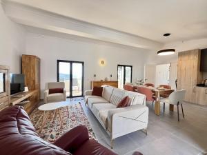 a living room with a couch and a table at Algarve Premium Villa With Pool by Homing in Santa Bárbara de Nexe