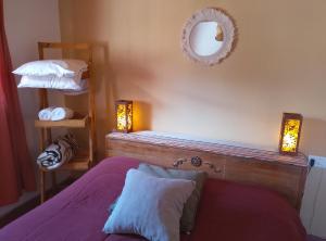 a bedroom with a bed and a mirror on the wall at Cabañas Rowal Malbec Potrerillos in Potrerillos