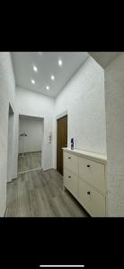 a white room with a dresser and a door at Stylish & Relaxing Modernes Apartment mit Privatparkplatz in Gelsenkirchen