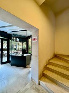 a lobby of a building with a sign that reads skilled at Downtown Grand Comfort in Tirana