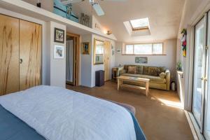 a bedroom with a large bed and a couch at Waterfront w views on Blackfish Creek in Wellfleet +22 photos