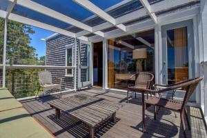 a patio with chairs and a table on a deck at National Seashore w Modern Architecture in Wellfleet