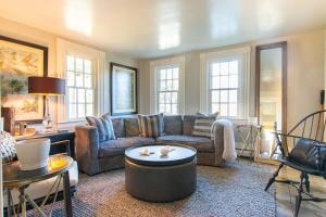 a living room with a couch and a table at Multi-Dwelling 1 Mile to Nantucket Sound in Dennis