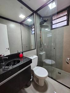 une salle de bain avec toilettes, douche et lavabo dans l'établissement Apartamento Confortavel 2 quartos ao lado Shopping, à Uberlândia 42 autres photos