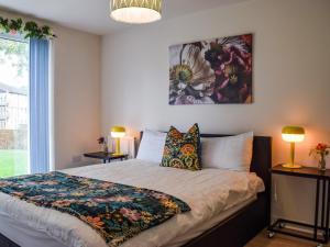 a bedroom with a bed and a painting on the wall at Frank Wright Apartment in Sheffield
