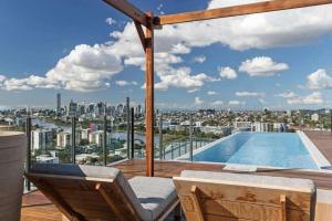 a balcony with a swimming pool and a view of the city at Modern APT in Toowong with Mountain View in Brisbane