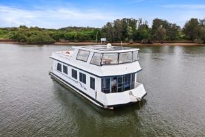 a boat on the water on a river at Coomera Houseboats in Gold Coast