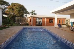 a swimming pool in front of a house at appartement cosy in Somone