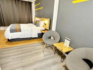 a bedroom with a bed and a chair and a table at Duncan Motel in Duncan +71 photos