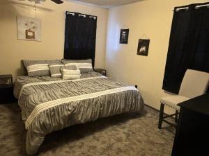 a bedroom with a bed and a chair at Murfreesboro Wandering Wagon Located in town in Murfreesboro