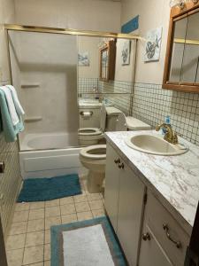 a bathroom with a tub and a toilet and a sink at Murfreesboro Wandering Wagon Located in town in Murfreesboro