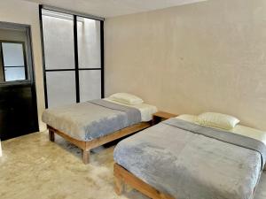 Ένα ή περισσότερα κρεβάτια σε δωμάτιο στο Suites Bacalar