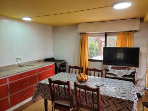 a kitchen with a table with a bowl of fruit on it at Casa Amarrilla in San Clemente del Tuyú
