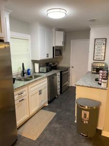 a kitchen with white cabinets and stainless steel appliances at 2-Bedroom Near Hospital and Casino in Pine Bluff