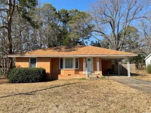a small house with a roof on a yard at 2-Bedroom Near Hospital and Casino in Pine Bluff