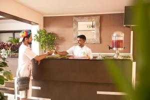 two men shaking hands in a kitchen at Westwood Residence in Mapusa +41 photos
