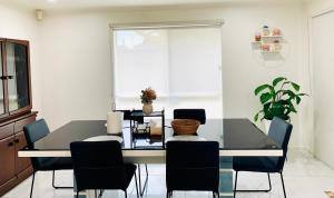 a dining room with a glass table and chairs at Welcome to Sunny Sanctuary in Carrum Downs