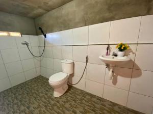 a bathroom with a toilet and a sink at Senaru sunset house in Senaru
