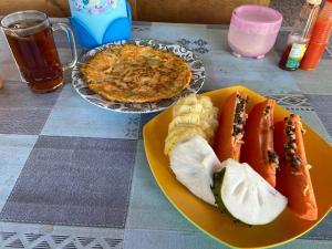 a table with two plates of food and a pie at Senaru sunset house in Senaru +37 photos