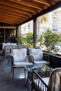 a group of chairs and tables on a patio at Arısan Otel in Silifke