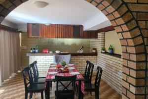 a dining room with a table and chairs in a kitchen at Big Holliday house with pool in Brisbane