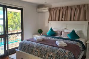 a bedroom with a large bed with blue pillows at Big Holliday house with pool in Brisbane +61 photos