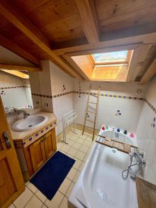 Un baño con una bañera grande y un lavabo. en Chalet les vergers, en Sallanches