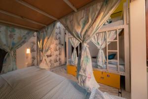 a bedroom with two bunk beds with curtains at Whereabout Hostel Udaipur in Udaipur
