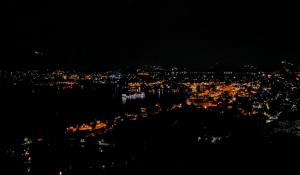 a view of a city lit up at night at Whereabout Hostel Udaipur in Udaipur