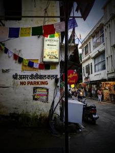 a street with a no parking sign on the side of a building at Whereabout Hostel Udaipur in Udaipur