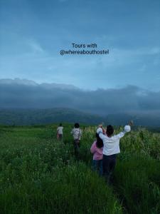 a group of people walking in a field at Whereabout Hostel Udaipur in Udaipur