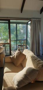 a large bed in a room with a large window at Premium Nelson Location in Nelson