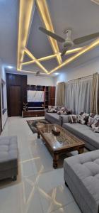 a living room with couches and a coffee table at Sapphire Residency in Niāziān