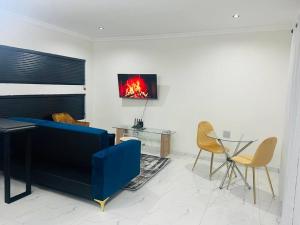a living room with a blue couch and a table at KT Comfort in Midrand